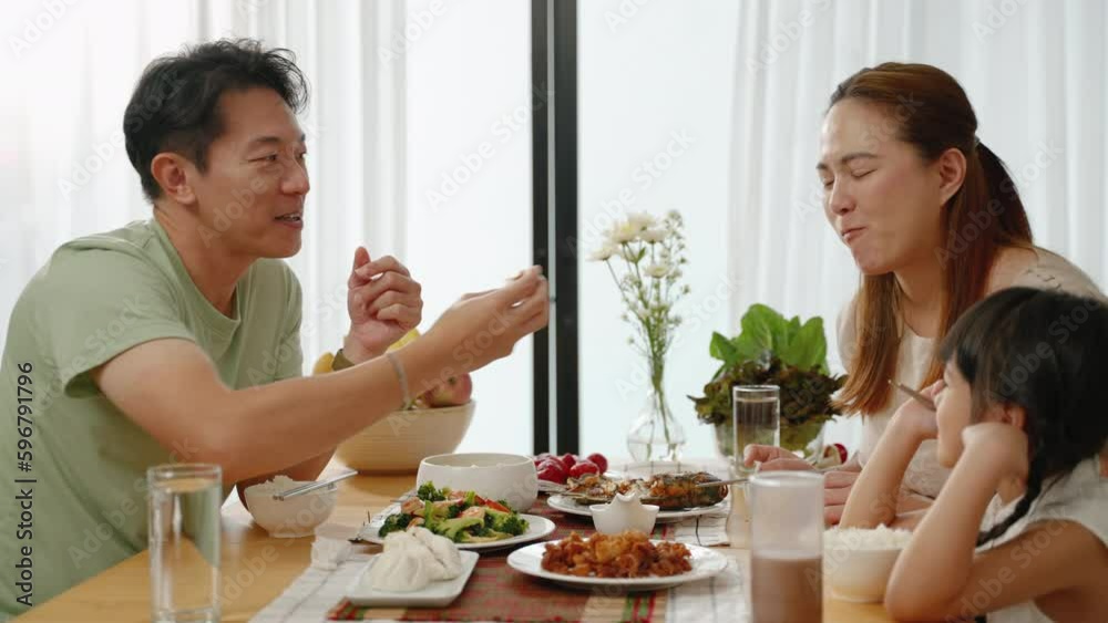 Asian family eating breakfast at the dining table inside the kitchen, family relationships
Asian family eating breakfast at the dining table inside the kitchen, family relationships