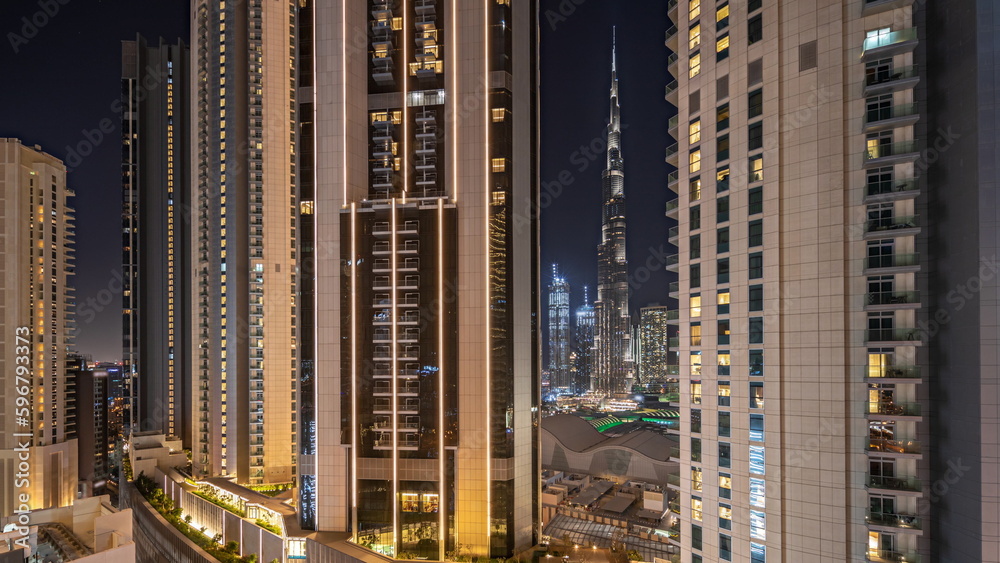 Tallest skyscrapers in downtown dubai located on bouleward street near shopping mall aerial night timelapse.