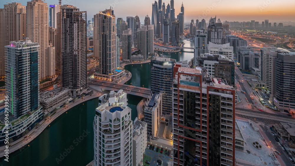 Obraz premium View of various skyscrapers in tallest recidential block in Dubai Marina aerial night to day timelapse