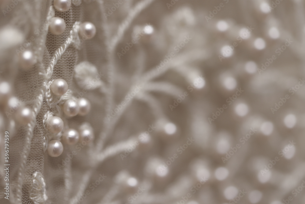 Fototapeta premium intricate design with pearls. Close up of detail on wedding gown