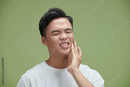 Man suffering from tooth ache in morning