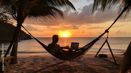 A digital nomad working while sitting in a hammock on a tropical beach with a beautiful sunset in the background. Generative Ai. photo