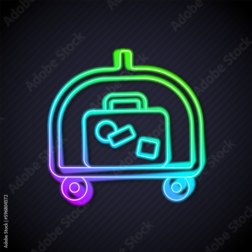 Glowing neon line Hotel luggage cart with suitcase icon isolated on black background. Traveling baggage sign. Travel luggage icon. Vector