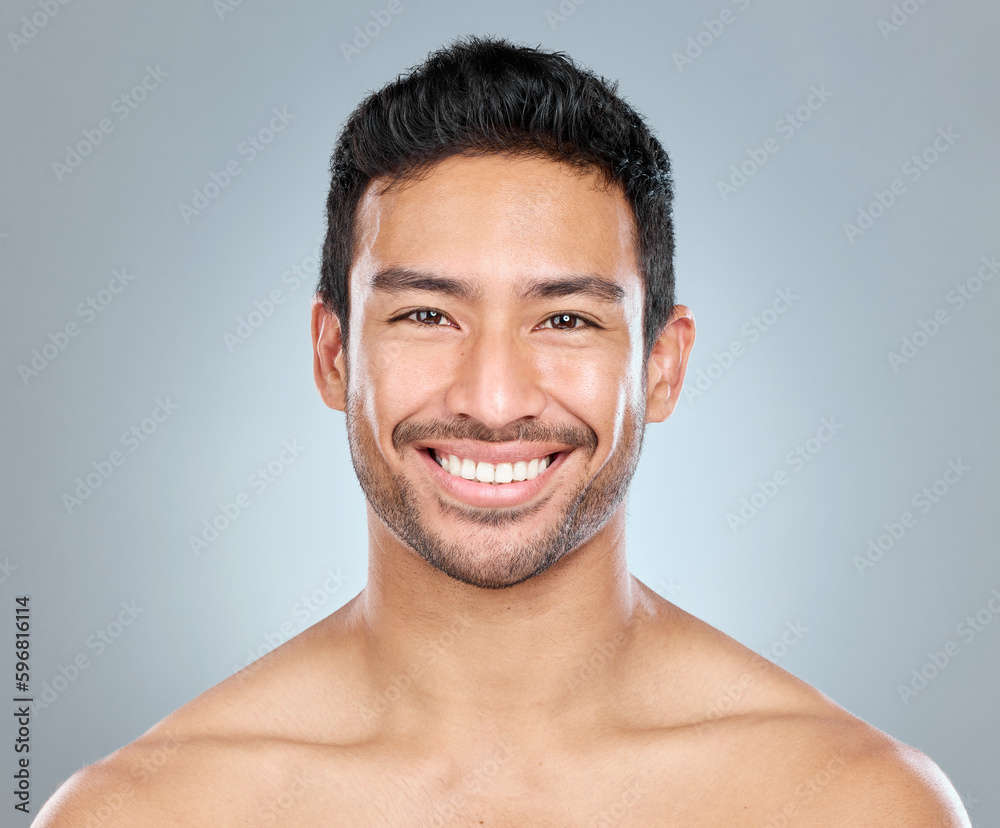 Hes a good looking dude. Shot of a handsome young man posing against a grey background. Hes a good looking dude. Shot of a handsome young man posing against a grey background.