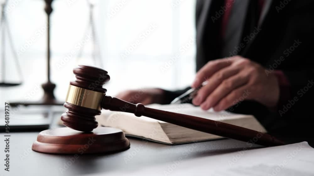 justice and law concept.Male judge in a courtroom on wooden table and Counselor or Male lawyer working in office. Legal law, advice and justice concept.