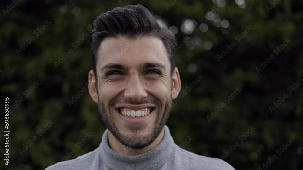Outdoor portrait: happy young man smiling at camera Outdoor portrait: happy young man smiling at camera