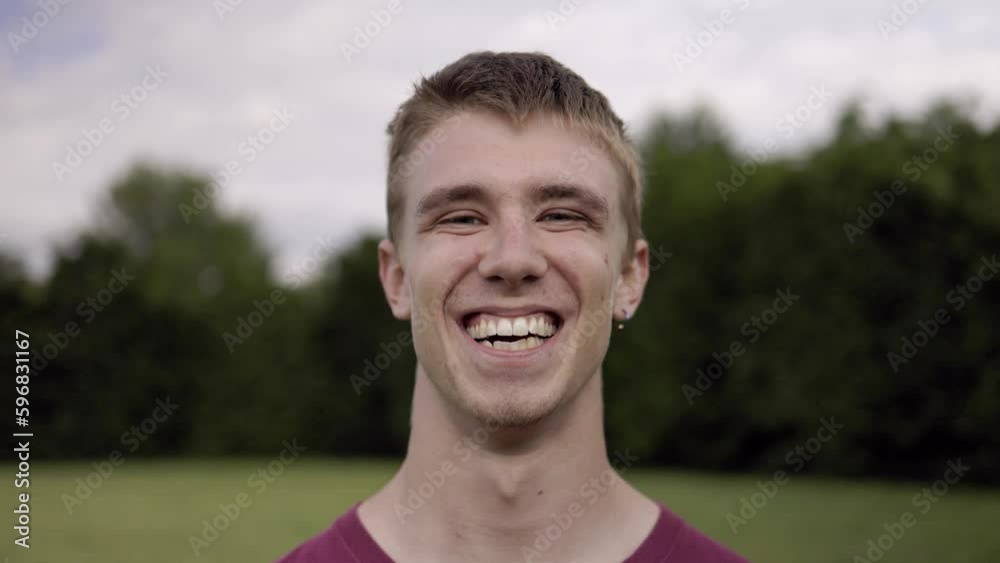 Outdoor portrait: happy young guy smiling at camera Outdoor portrait: happy young guy smiling at camera