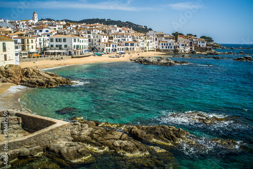 A classic white town on the Costa Brava. White houses, historical buildings of Calella de Palafrugell. Rocks, beach and sea view photo