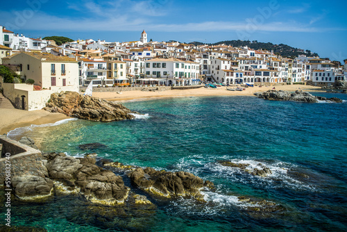 A classic white town on the Costa Brava. White houses, historical buildings of Calella de Palafrugell. Rocks, beach and sea view photo