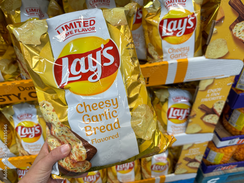 Maple Grove, Minnesota April 8, 2023 Hand holds up a package of Lays