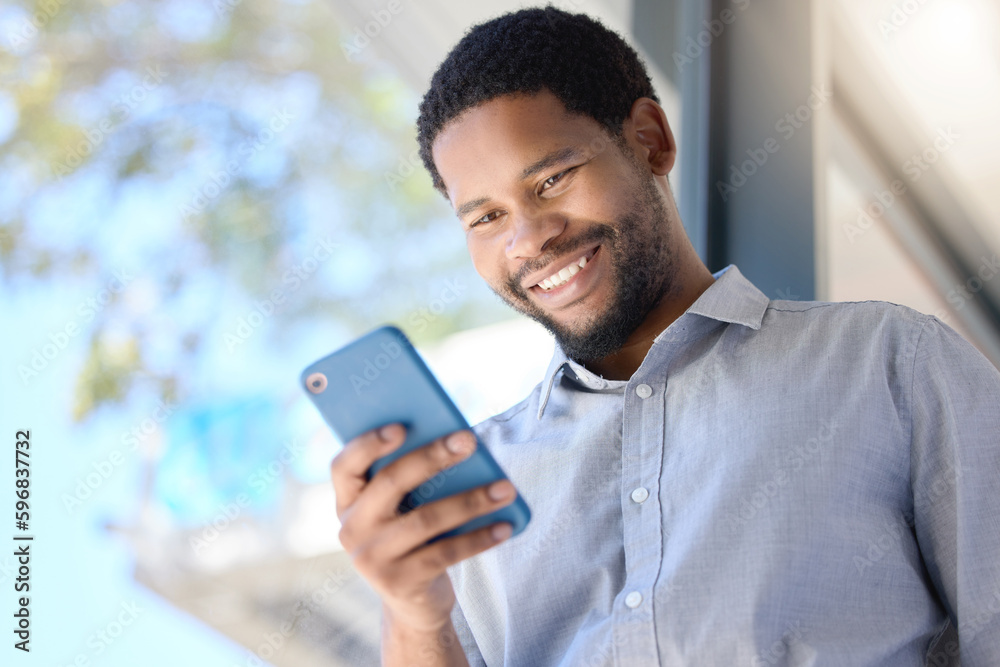 Keeping up with connections. Low angle shot of a young businessman using a cellphone in an office. Keeping up with connections. Low angle shot of a young businessman using a cellphone in an office.