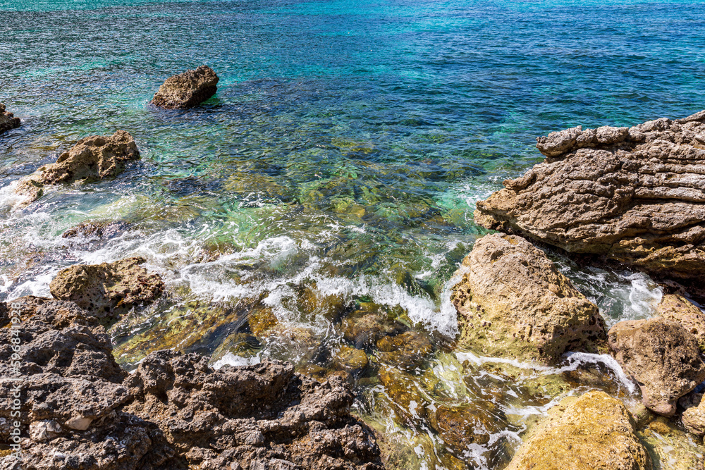 A beautiful landscape of the coast of the island of Corfu in the Ionian Sea of the Mediterranean in Greece. Pure blue clear water washes over the shores of the Greek island. A beautiful landscape of the coast of the island of Corfu in the Ionian Sea of the Mediterranean in Greece. Pure blue clear water washes over the shores of the Greek island.
