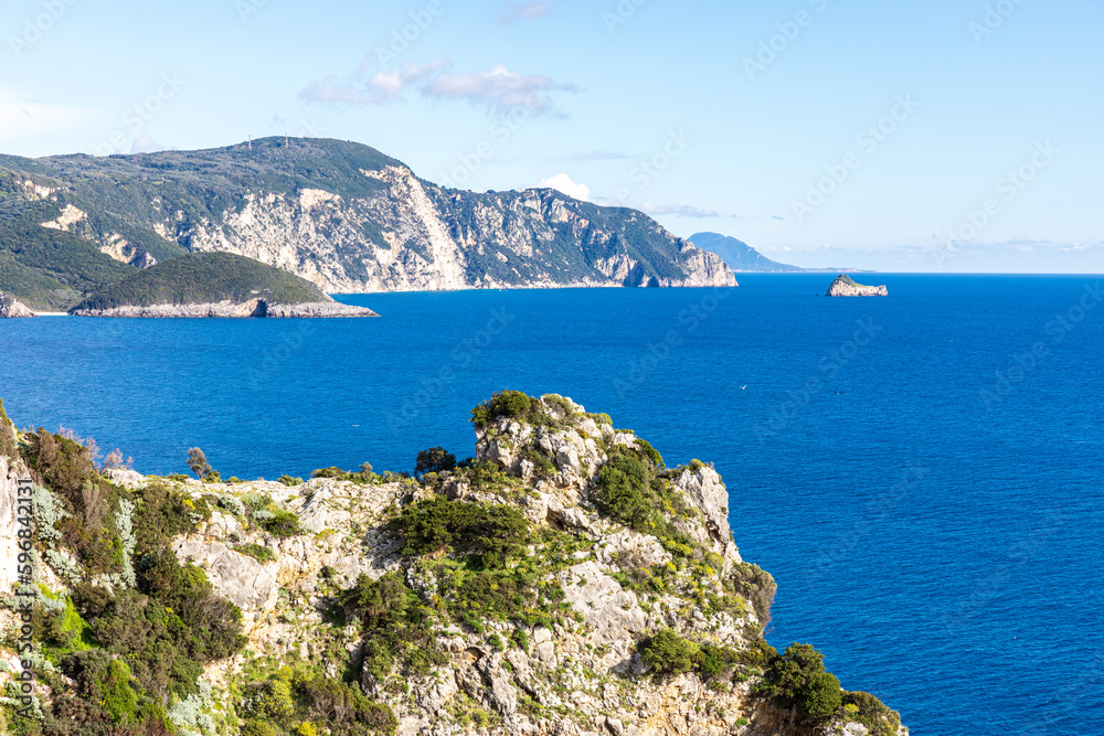 A beautiful landscape of the coast of the island of Corfu in the Ionian Sea of the Mediterranean in Greece. Pure blue clear water washes over the shores of the Greek island. A beautiful landscape of the coast of the island of Corfu in the Ionian Sea of the Mediterranean in Greece. Pure blue clear water washes over the shores of the Greek island.