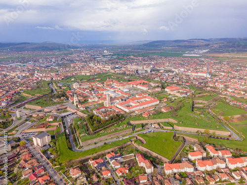 Aerial view of the Alba Carolina citadel located in Alba Iulia, Romania. The photography was shot from a drone with the camera level for a panoramic view of the star shaped citadel.