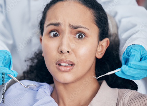 Oh no will this hurt. Shot of a young woman looking afraid at her dentists office.