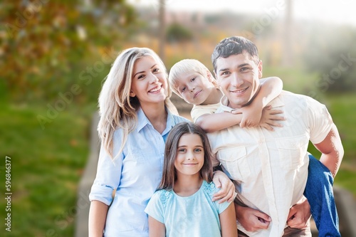 Happy young family walking at park