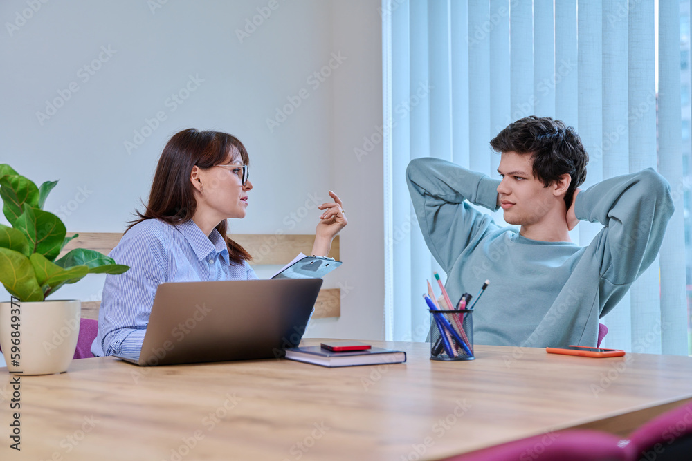 Guy student at therapy meeting with psychologist, mentor in college office Guy student at therapy meeting with psychologist, mentor in college office