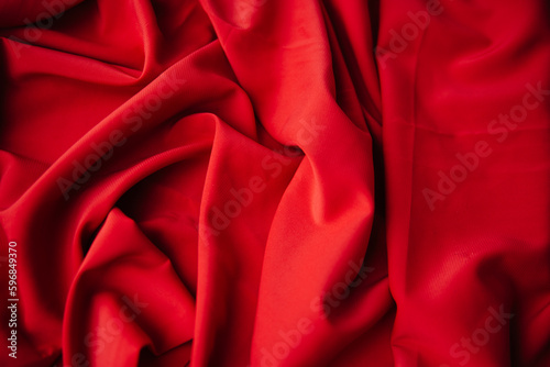 Texture of dense fabric red gabardine. Textile drapery satin photo