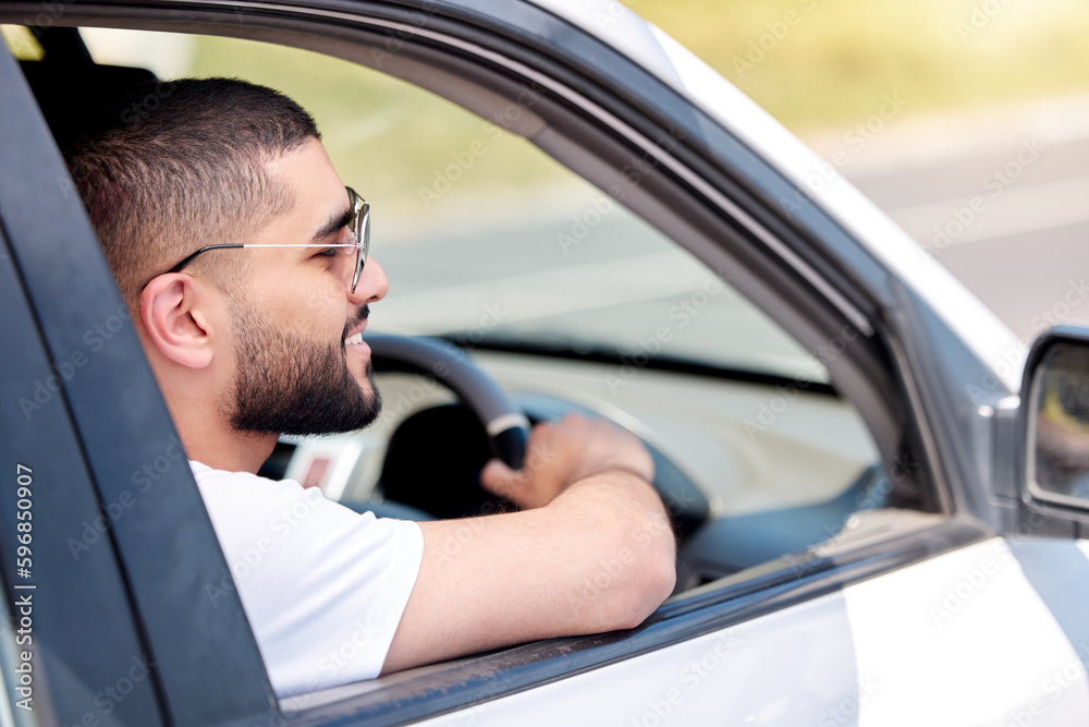 Take a drive with me. Cropped shot of a handsome young man wearing sunglasses while driving his car.