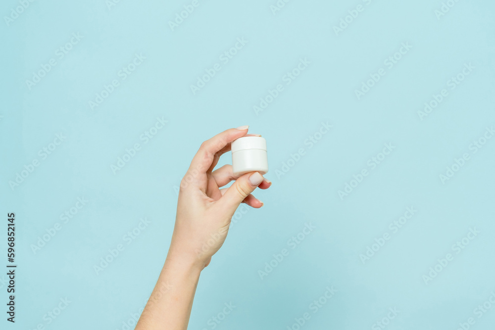 Jar of cream or ointment in hand. Packaging cosmetic product Jar of cream or ointment in hand. Packaging cosmetic product