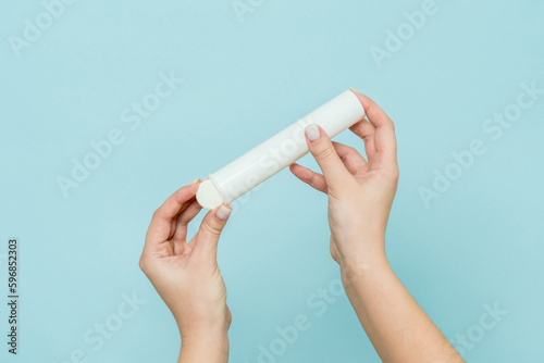 Packaging for vitamins, pills with tablet in hand. White tube. Mockup