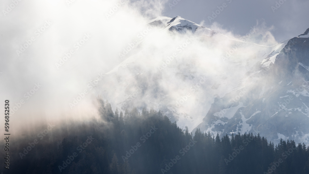 Golden fog in the snowy Bucegi mountains and forest 
