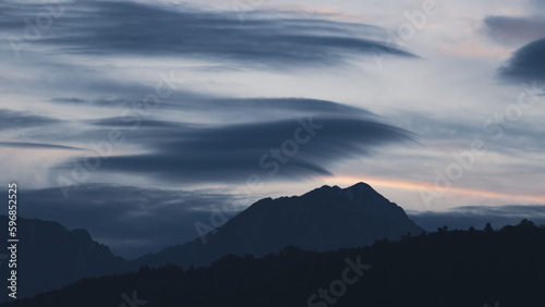 Dramatic altostratus clouds and rainbow in Piatra Craiului mountains at sunset