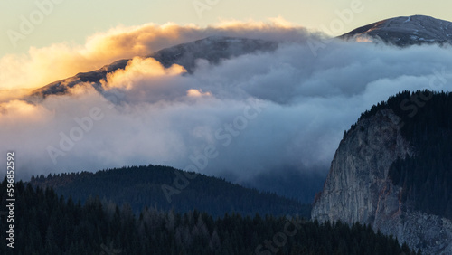 Landscape of a cold sunset in the Bucegi mountains with golden clouds 
