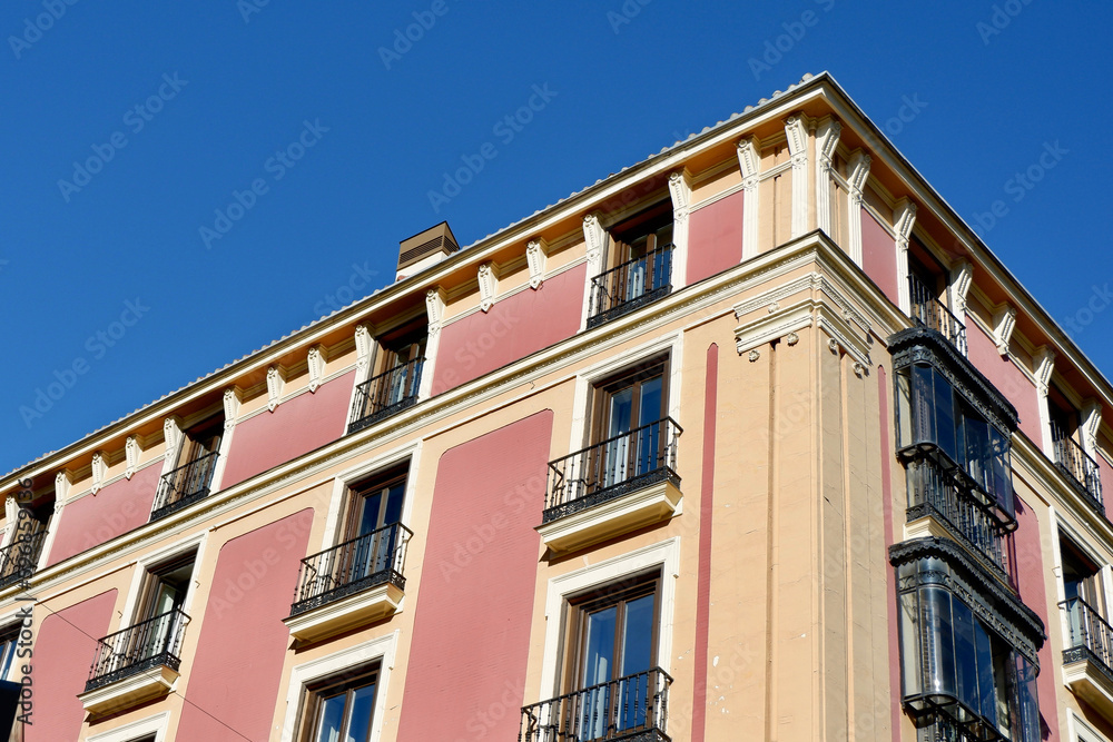 Corner of vintage building of pink purple colour downtown district of Madrid, Spain. Authentic Spanish architecture