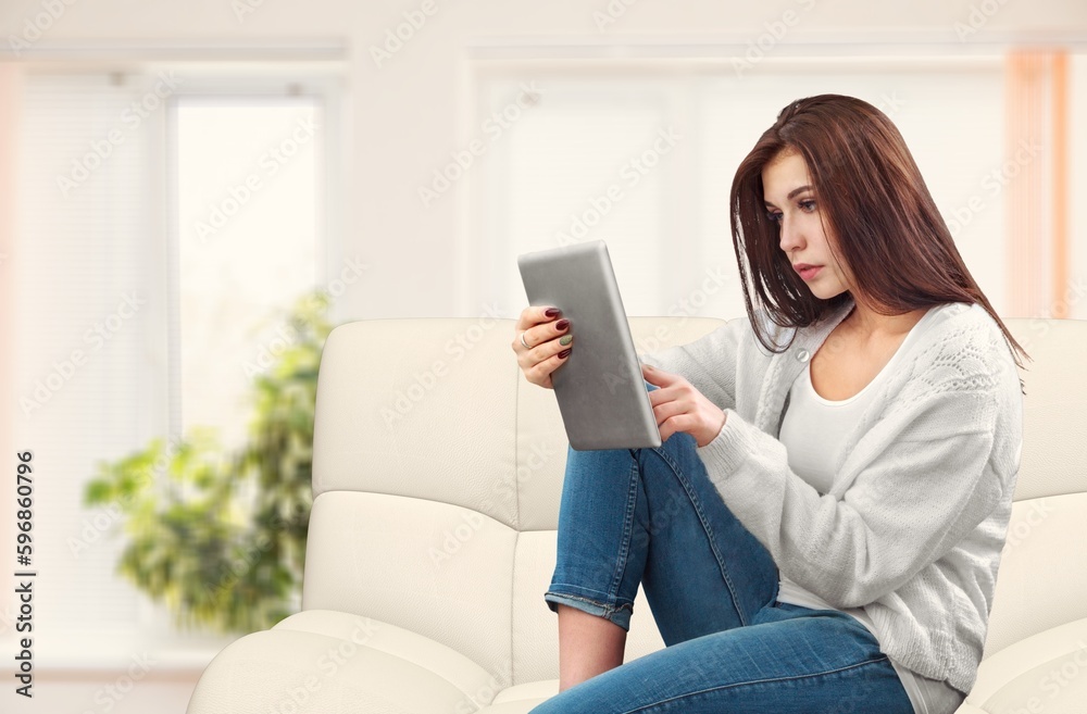 Attractive happy young woman with digital tablet