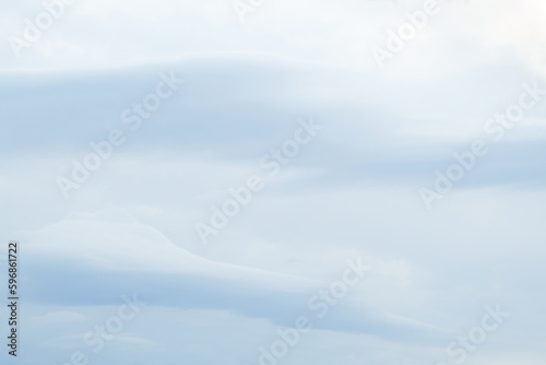 Pale blue sky and clouds background 