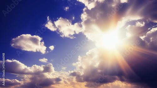 The bright sun shines from behind the clouds in the blue sky. The sun's rays shine on the clouds. International Sun Day. Generated AI.