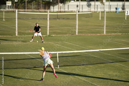 Amateur Tennis player, playing tennis at a tournament and match on grass in Europe 