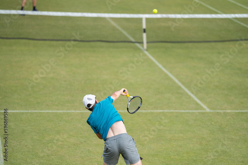 Amateur Tennis player, playing tennis at a tournament and match on grass in Europe  © William
