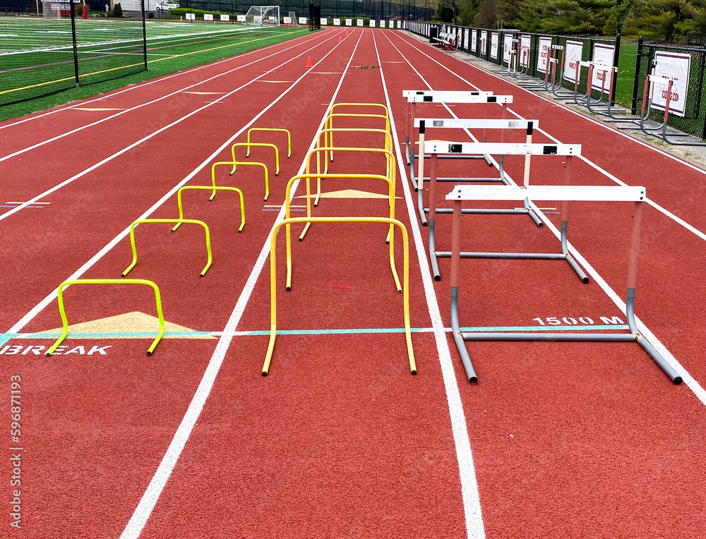 Three different sizes of hurdles in ows on a track for training