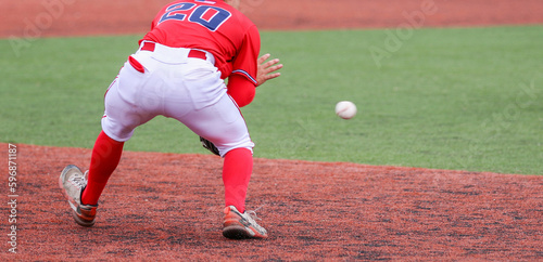 Third baseman fielding the ball during a baseball game photo