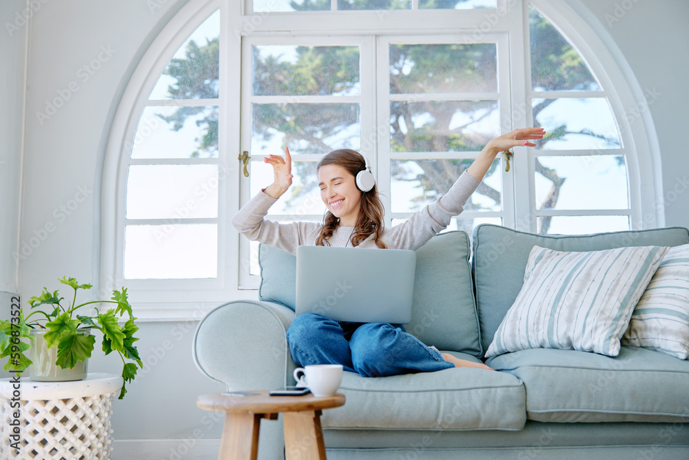 Get lost in your favourite song. Full length shot of an attractive young woman listening to music while relaxing on the sofa at home. Get lost in your favourite song. Full length shot of an attractive young woman listening to music while relaxing on the sofa at home.