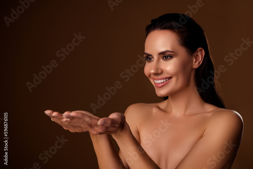 Photo of gorgeous model lady hold open palms arms advice beauty product salon offer isolated brown background