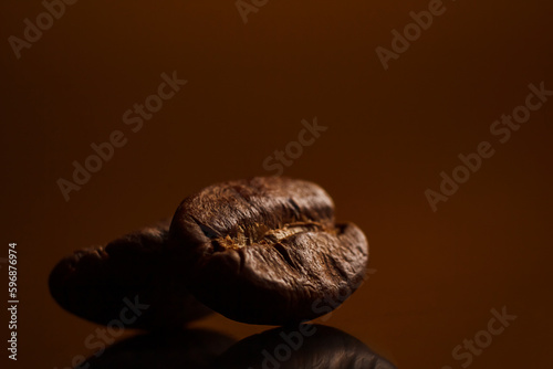 coffee beans on a dark background with a yellow highlight on the background, coffee beans close-up for a coffee shop