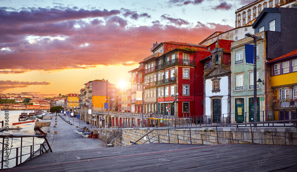 Porto, Portugal. Promenade in city porto over river Douro, with vintage authentic houses. Old cityscape sunrise and vibrant sunset evening sky