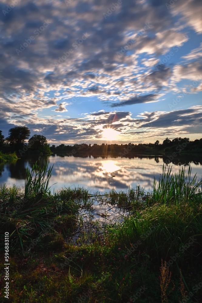 Beautiful colorful landscape by the lake in the countryside. Sunset on the Mojcza lake near Kielce, Poland.