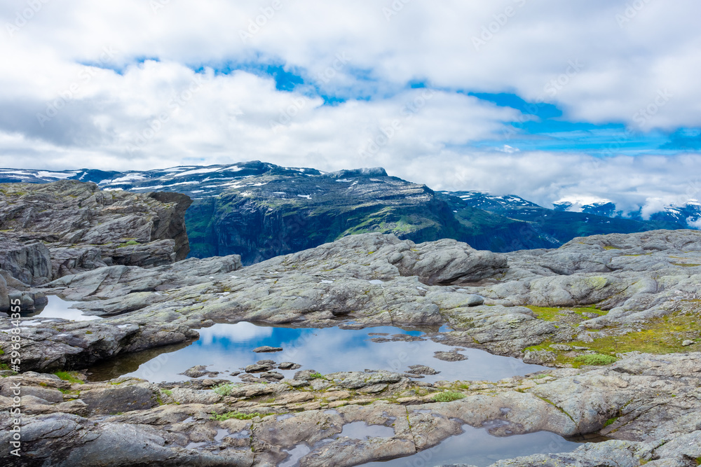 Beautiful blue ponds in the hiking trail of Trolltunga, Odda,  Norway