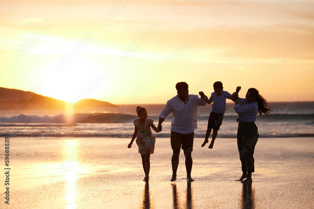 Fototapeta premium So alive. Shot of an unrecognizable family bonding while spending a day at the beach together.