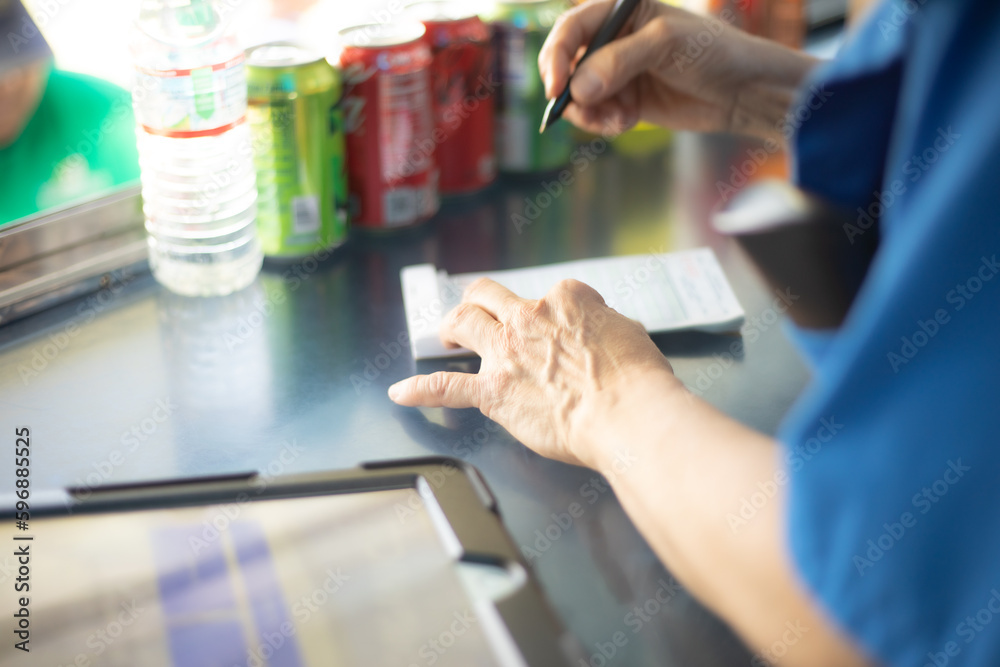 Fototapeta premium Close up of Food Truck Cashier taking food order on pad of paper