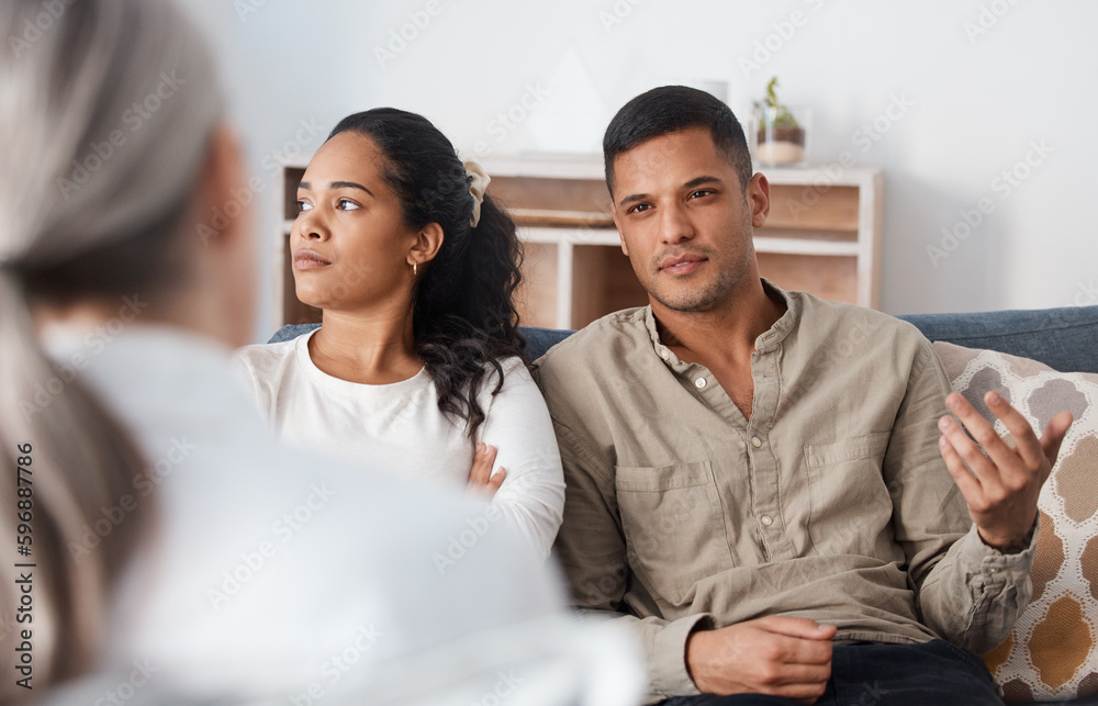 There he goes with the lies again. Shot of a young couple sitting together and looking annoyed during a consultation with a psychologist. There he goes with the lies again. Shot of a young couple sitting together and looking annoyed during a consultation with a psychologist.