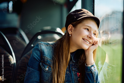 Happy little girl daydreaming while riding in bus.