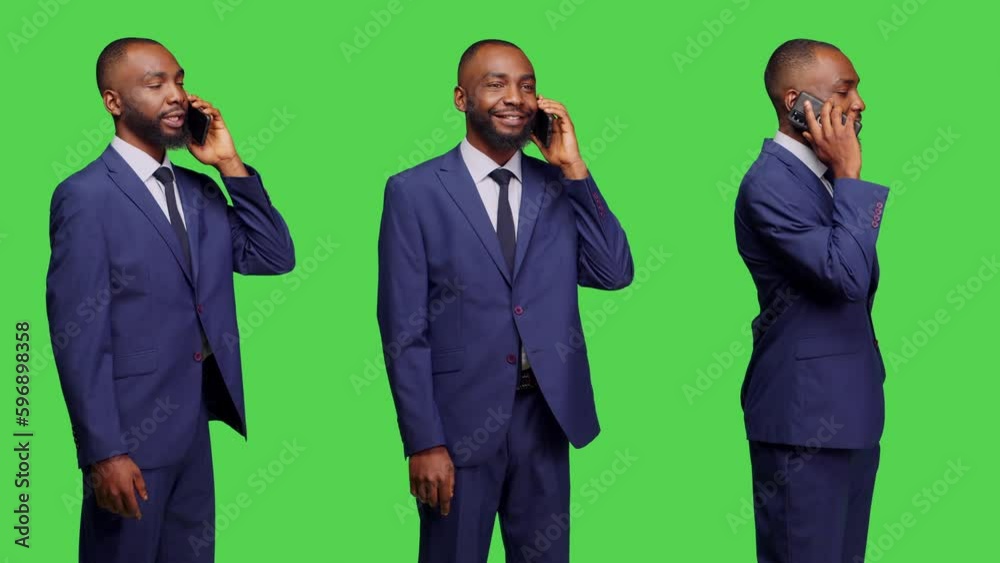 Corporate worker talking on mobile phone call in studio, having remote conversation on telephone line. Businessman using smartphone over green screen background, formal male model. Corporate worker talking on mobile phone call in studio, having remote conversation on telephone line. Businessman using smartphone over green screen background, formal male model.