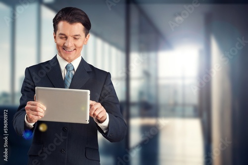 Young happy business man using digital tablet