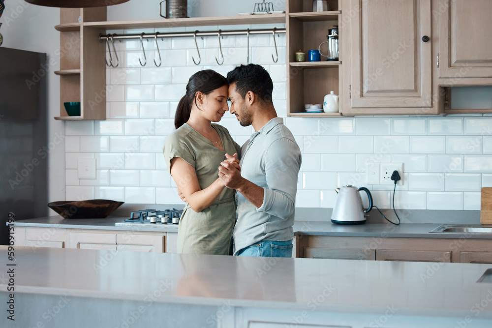 Lets make the most of this moment. Shot of a young couple dancing in the kitchen at home. Lets make the most of this moment. Shot of a young couple dancing in the kitchen at home.