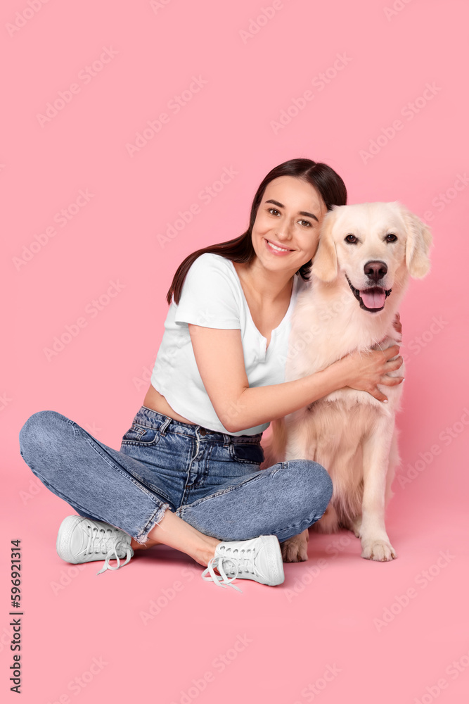 Happy woman with cute Labrador Retriever dog on pink background. Adorable pet Happy woman with cute Labrador Retriever dog on pink background. Adorable pet
